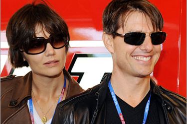 AFP / US actor Tom Cruise and his wife Katie Holmes look at Australian MotoGP rider Casey Stoner's Ducati before the Red Bull US Grand Prix in Laguna Seca, California, July 20,