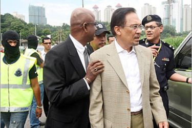 AFP / Malaysian opposition leader Anwar Ibrahim is arrested by police near his house in Kuala Lumpur on July 16, 2008. Malaysian opposition leader Anwar Ibrahim, who was arrested over sodomy allegations, spent the night in
