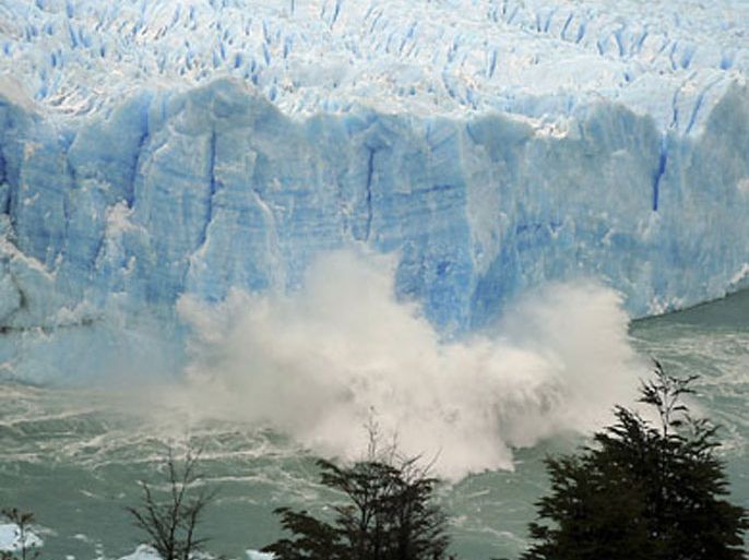 Splinters of ice peel off from one of the sides of the Perito Moreno glacier as the waters of Lake Argentino open a tunnel in the glacier in a process of a unexpected rupture during