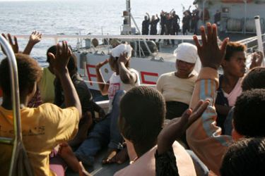 Illegal immigrants are rescued by Italy's coast guard after they were intercepted on a boat off Italy's southern island of Lampedusa on August 3, 2008. Sicily and Lampedusa