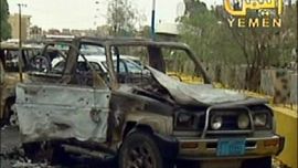 afp : A grab taken from the Yemeni television shows a burnd cars outside the US embassy following an attack in the capital Sanaa on September 17, 2008. Islamist militants