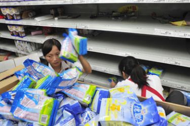 Employees remove contaminated milk formula products from the shelves of a supermarket in Hefei, Anhui province September 16, 2008. China said on Wednesday a third infant