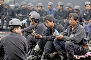 REUTERS/Rescuers sit on the ground at the Xinfeng No. 2 Coal Mine, where a gas "outburst" occurred, in Dengfeng, Henan province September 21, 2008