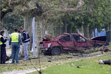 REUTERS/Police examine the site of a car bomb attack on a Spanish military training centre in Santona September 22, 2008. A soldier was killed and another