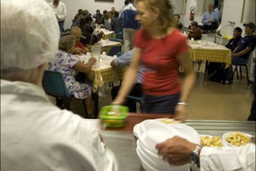 r : Diners eat free meals in a "soup kitchen" run by the Sant'Egidio Christian community in Rome September 17, 2008. The euro zone's third largest economy, Italy has been