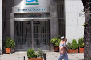 f_A picture taken on May 13, 2008 shows people walking near the headquarters of French banking giant Credit Agricole in Paris. Eight European mutual banks have