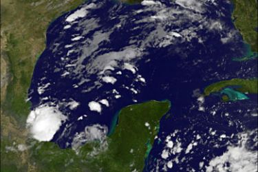 afp : This October 8, 2008 NOAA satellite image show Tropical Storm Marco (lower-L) as it approaches the eastern coast of Mexico. A hurricane watch was issued for Mexico's