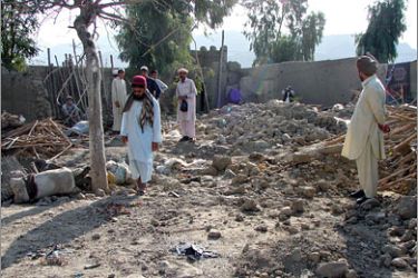 AFPPakistani tribesmen gather over the destroyed residence of suspected Taliban militant Omar Daraz following a US missile strike in Miranshah,
