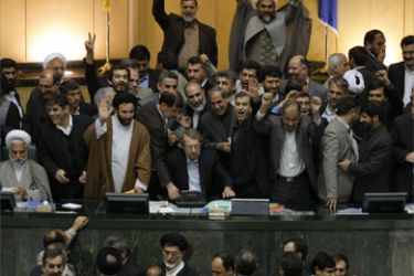 Iran's Parliament Speaker Ali Larijani (seated-C) counts the votes with MPs gathered around him at the parliament to hear the result of the count on the approval of Iranian President Mahmoud Ahmadinejad's nominee as interior minister, Sadeq Mahsouli, in Tehran on November 18, 2008.