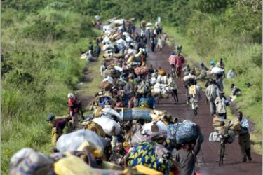 AFP - Internally Displaced People (IDPs) leave Kibati heading north from the city to their villages, Kibumba and Rugari, north of the provincial capital of Goma, Congo, on November 2, 2008