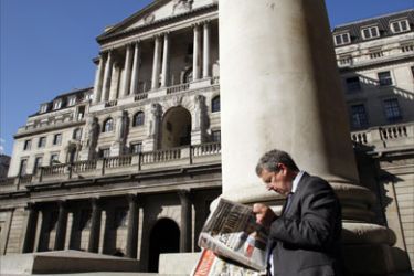 A file picture taken on October 8, 2008 in London shows a city worker reading a newspaper opposite the Bank of England.
