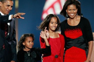 U.S. President elect Barack Obama (L) acknowledges his supporters along with his wife Michelle (R) and daughters Malia (2nd R) and Sasha to during an election night gathering in Grant Park on November 4, 2008 in Chicago, Illinois.