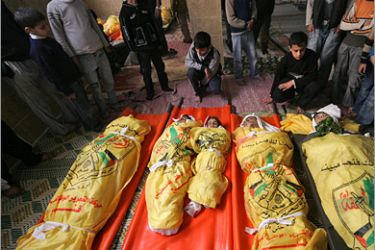 AFP - Palestinian children mourn over the bodies of five civilians, of which two young siblings (C), killed by Israeli fire in Beit Lahia, northern Gaza Strip on January 17, 2009. Israel