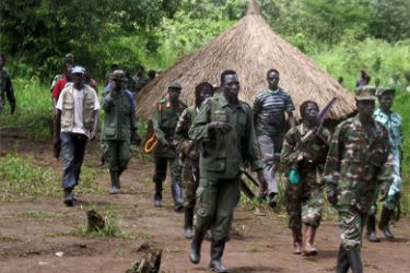 A picture taken on September 2006, 20 shows a column of around 40 Lord's Resistance Army (LRA) fighters emerging from thick bush at Ri-Kwangba on southern Sudan's border with the Democratic Republic of Congo