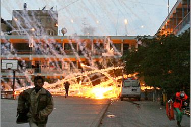. AFP - Palestinian civilians and medics run to safety during an Israeli strike over a UN school in Beit Lahia, northern Gaza Strip early on January 17, 2009. A woman and a child were killed early today in the Israeli strike on the UN-run school in