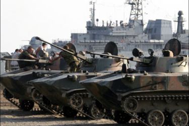 r : File photo of Russian armoured vehicles boarding a naval ship to leave for Russia at the Black Sea coast near Sukhumi August 23, 2008. The separatist region of Abkhazia
