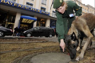 afp : Police use sniffer-dogs to check for explosives at a drain on February 6, 2009 in front of the Bayerischer Hof hotel in Munich, southern Germany the venue of the Munich