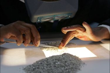 afp : (FILES) File photo dated on March 17, 2008 shows a Botswana staff sorting diamonds at the new Diamond Trading Company (DTC) Botswana building in Gaborone.
