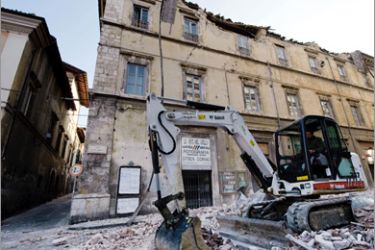 AFP - Workers remove debris on April 6, 2009 in the center of the Abruzzo capital L'Aquila, the epicenter of an earthquake measuring 5.8-magnitude on the open-ended Richter scale. At least 20 people were killed in an earthquake that struck central Italy as most people lay sleeping early on April 6, and