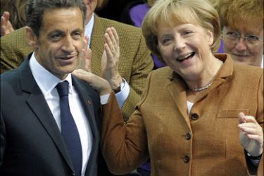 afp : French President Nicolas Sarkozy and German Chancellor Angela Merkel smileon the podium at the Sony Centre in Berlin on May 10, 2009. Sarkozy attended the