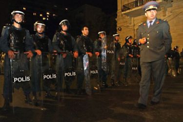 Azeri riot policemen stand ready to charge supporters of oppositional leader Isa Gambar during an overnight demonstration at the headquarters of the oppositional party Musavat in Baku, Wednesday 15 October 2003
