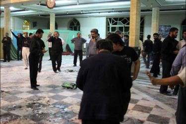 afp : BYLINE CORRECTIONIranian security personnel and civilians inspect the site of a bomb blast inside the Amir al-Momenin mosque in the southeastern Iranian city of