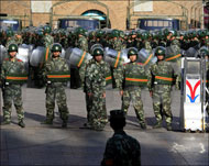 جنود صينيون يحرسون مدخل أحد المساجد في أورومشي أمس (رويترز)