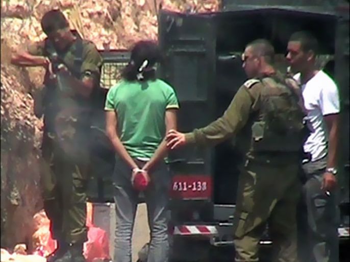 afp : (FILE) A handout still video image made available by Israeli human rights group B'Tselem on July 21, 2008, shows an Israeli soldier apparently shooting a rubber bullet towards