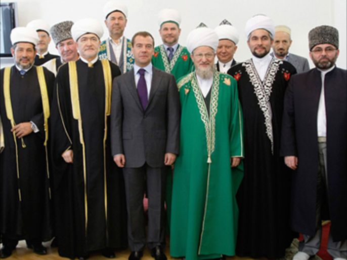 Russian President Dmitry Medvedev (C) poses for a group photo with members of the Russian Council of Muftis in Moscow on July 15, 2009 during a tour of the city's main