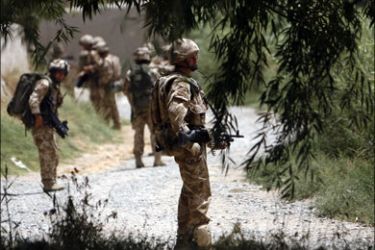 r : British troops from the Royal Regiment of Scotland (3 SCOTS) patrol a Taliban-held area of Afghanistan's Helmand province during operation Panther's Claw July 11, 2009.