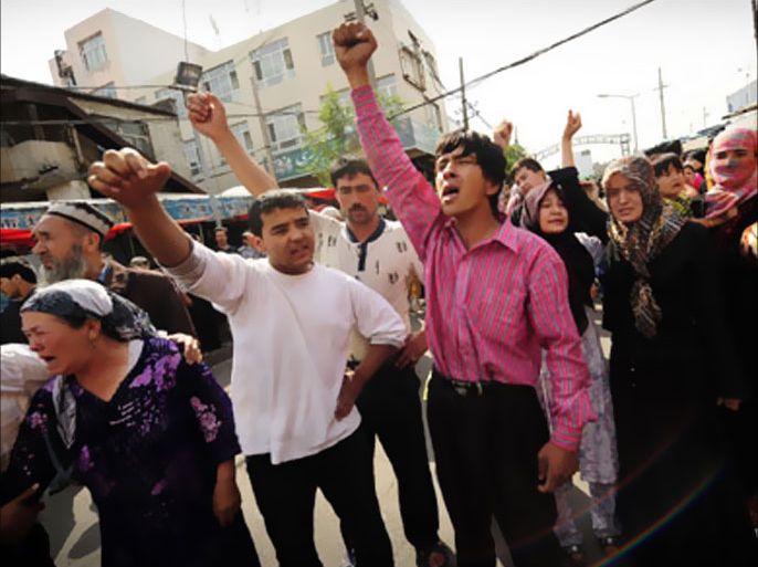 Muslim ethnic Uighurs protest in Urumqi in China's far west Xinjiang province on July 7, 2009. Police fired tear gas to disperse thousands of Han Chinese protesters armed with