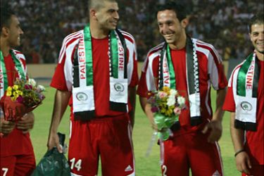 Palestinian players smile at the start of their friendly match against Iraq in the northern city of Arbil, 350 kms from the capital Baghdad, on July 10, 2009.