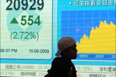 afp : Pedestrians walk past a graph showing the Hang Seng index in Hong Kong on August 10, 2009. Hong Kong share prices closed up 2.72 percent at a near 12-month high,