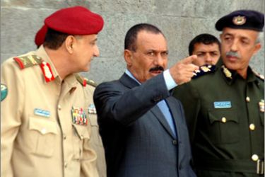 AFP Yemeni President Ali Abdullah Saleh (C) attends with his Defence Minister Mohammed Nasser Ahmed Ali (L) and head of the police academy (R)