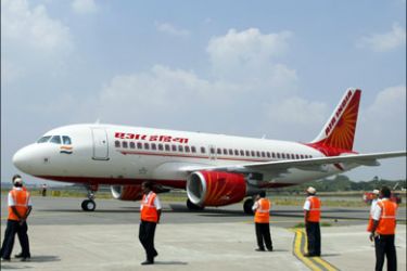 afp : India-economy-aviation BY SALIL PANCHAL(FILES) A file picture taken on october 15, 2008, shows ground crew standing next to a newly-inducted Air India Airbus A319 aircraft during the opening day of India