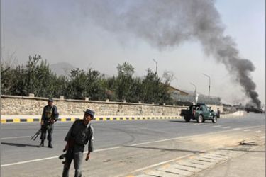 Afghan policemen block a road leading to the site of a blast outside a NATO military base in Kabul September 8, 2009
