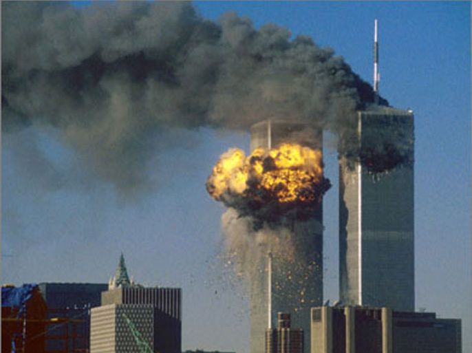 The World Trade Center south tower (L) bursts into flames after being struck by hijacked United Airlines Flight 175 as the north tower burns following an earlier attack by a hijacked airliner in New York City in this September 11, 2001 file photo.