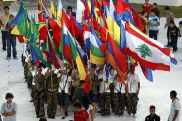 Lebanese volunteers and soldiers hold flags of countries competing in the Francophone Games during rehearsals for the opening ceremony at the Camille Chamoun sports stadium in Beirut on September 25, 2009. Starting September 27, Lebanon plays host to the Francophone Games