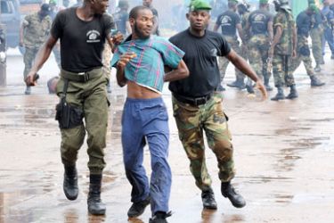 Guinean police arrest a protester on September 28, 2009 in front of the biggest stadium in the capital Conakry during a protest banned by Guinea's ruling junta.