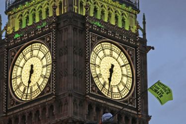 A flag flaps in front of Big Ben after Greenpeace demonstrators scaled the roof of the Houses of Parliament to protest against perceived government inaction on climate