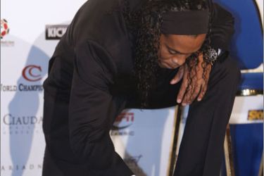 Brazilian AC Milan's football player Ronaldinho signs his foot print on October 12, 2009 in Monaco after he won the 2009 Golden Foot Award