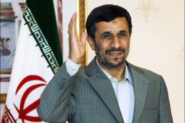 r : Iran's President Mahmoud Ahmadinejad waves as he waits for Turkey's Prime Minister Recep Tayyip Erdogan before their meeting in Istanbul, November 8, 2009. Iran's
