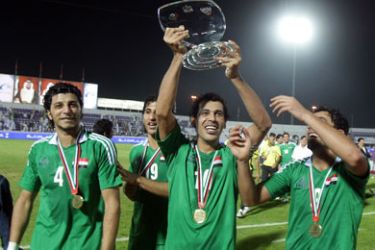 Iraqi players celebrate with the trophy after winning the United Arab Emirates International Cup final football match in the Gulf emirate of Al-Ain on November 18, 2009. Iraq beat UAE 1-0 to win the four-team friendly tournament.