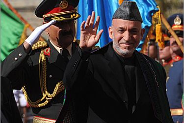Afghan President Hamid Karzai (L) gestures upon his arrival for his swearing in ceremony as the country's president for another five years at the Presidential Palace in Kabul on