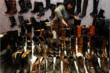 A customer selects boots at a leather shoes store in Changzhi, Shanxi province, November 20, 2009. A key European Union trade panel rejected on Thursday a European Commission proposal to extend dumping duties