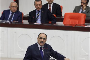 Turkey's Interior Minister Besir Atalay, with Prime Minister Tayyip Erdogan (first row, 2nd L) and his ministers in the background, addresses MPs during a debate at the Turkish Parliament in Ankara, November 13, 2009.