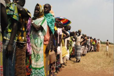 Southern Sudanese wait in line to receive rations of food airdropped earlier from the United Nations World Food Programme over the village of Pochalla, in the eastern state of Jonglei, on November 10, 2009.