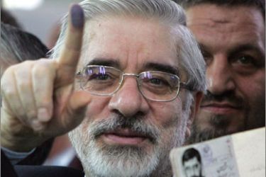 File picture dated June 12, 2009 shows former Iranian Prime Minister and presidential candidate, Mir Hossein Mousavi holding his certification card and ink-stained finger before voting at Ershad mosque in south of Tehran.
