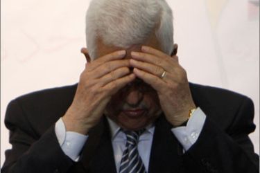 Palestinian President Mahmoud Abbas prays during a meeting of the Palestine Liberation Organisation (PLO) central council in the West Bank city of Ramallah