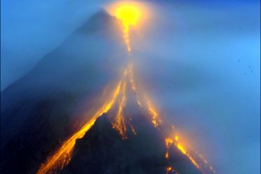 afp : Lava cascades on the slopes of the Mayon volcano as seen from Legazpi City, Albay province, 330 kilometres southeast of Manila on December 28, 2009. The Philippine